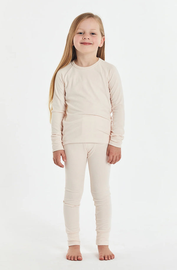 Girl standing against white background wearing the sleep set in shell