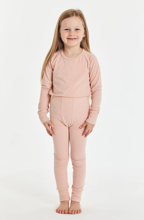 Girl standing against white background wearing the sleep set in misty rose