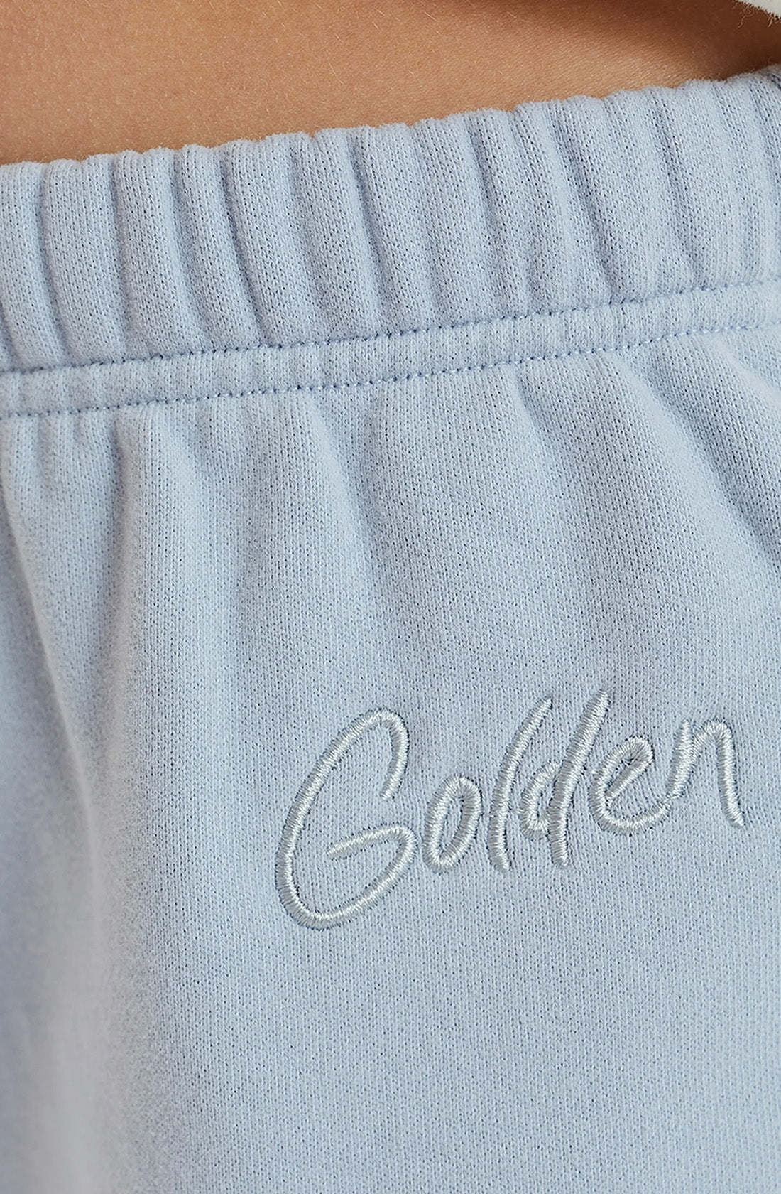 Close up of GOLDEN embroidery near the waistband of the pants