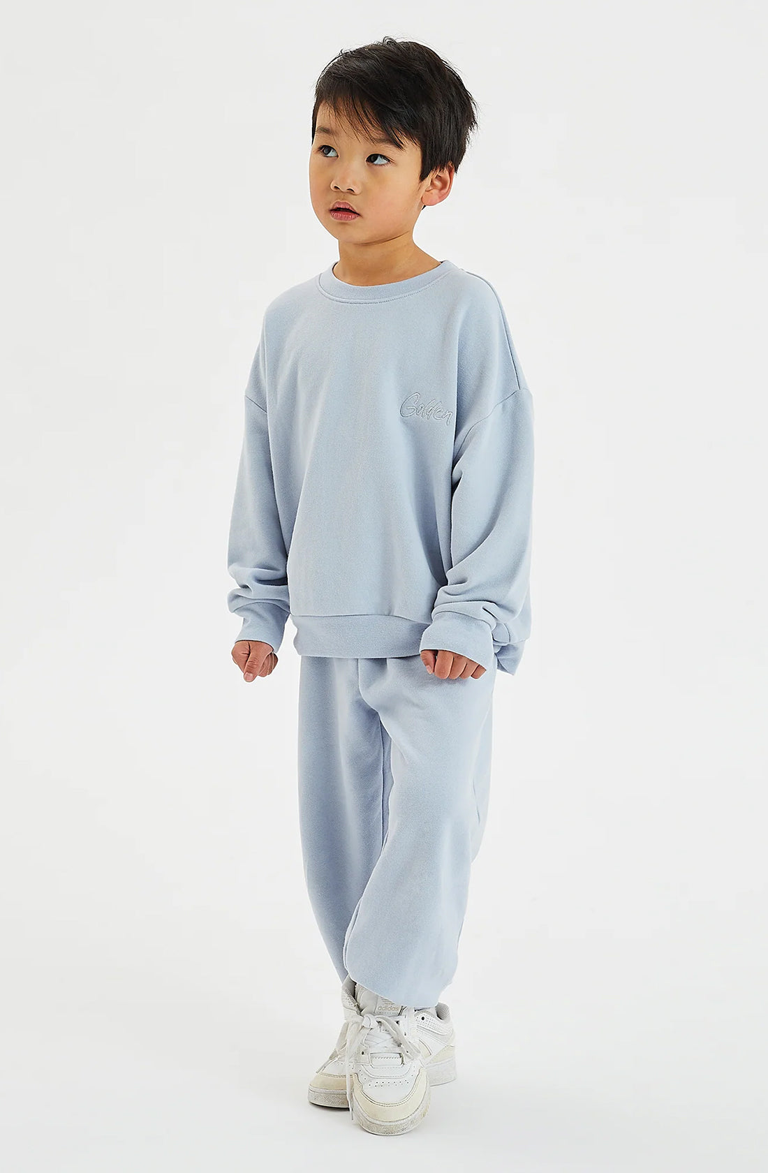 Boy wearing matching pale blue fleece set