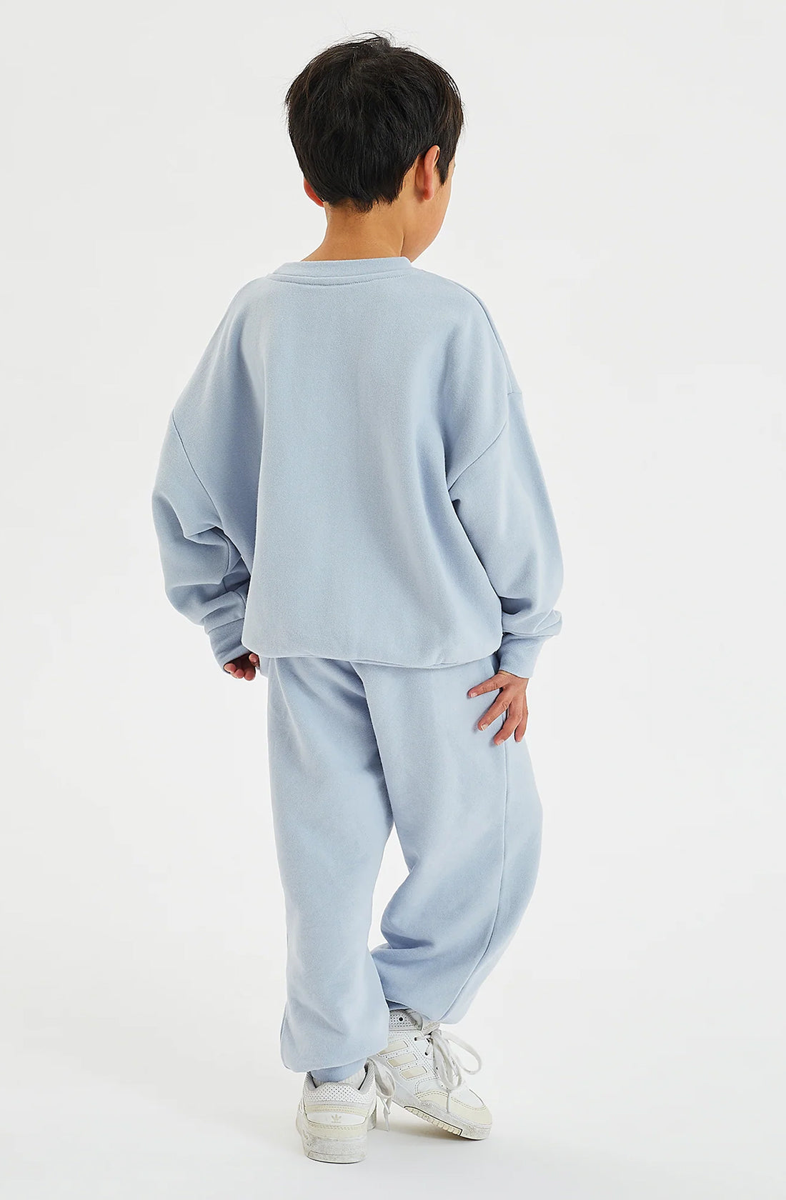 Rear view of boy wearing pale blue fleece set