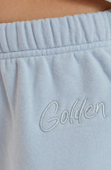 Close up of GOLDEN embroidery near the waistband of the pants