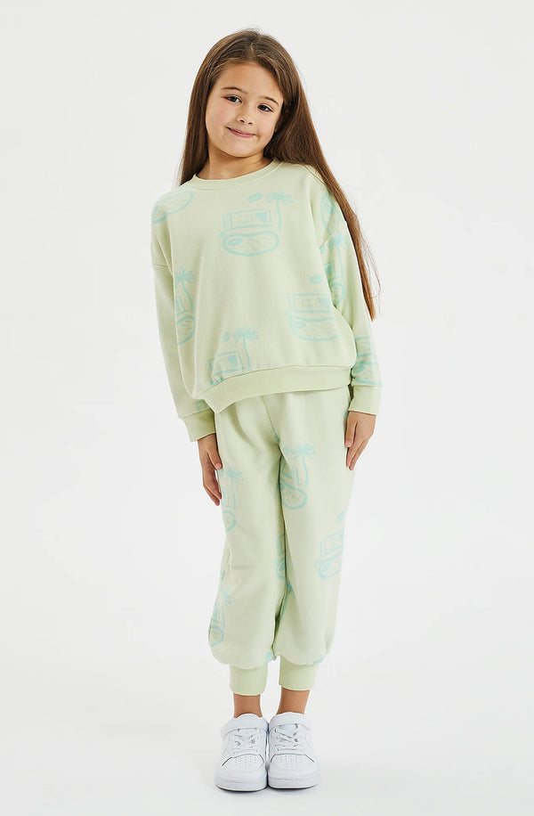 Girl wearing pool house print fleece set against a white background