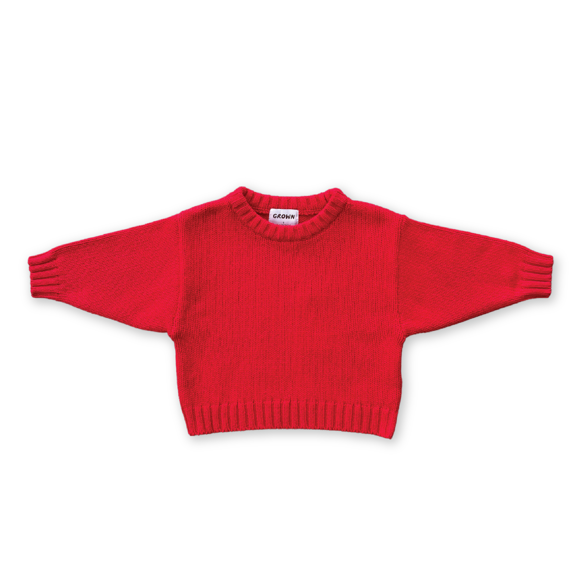 The GROWN Merino Blend Everyday Pull Over Flame is a bright red, long-sleeved children's knit sweater made from extrafine Merino wool, shown flat with sleeves outstretched on a black background.
