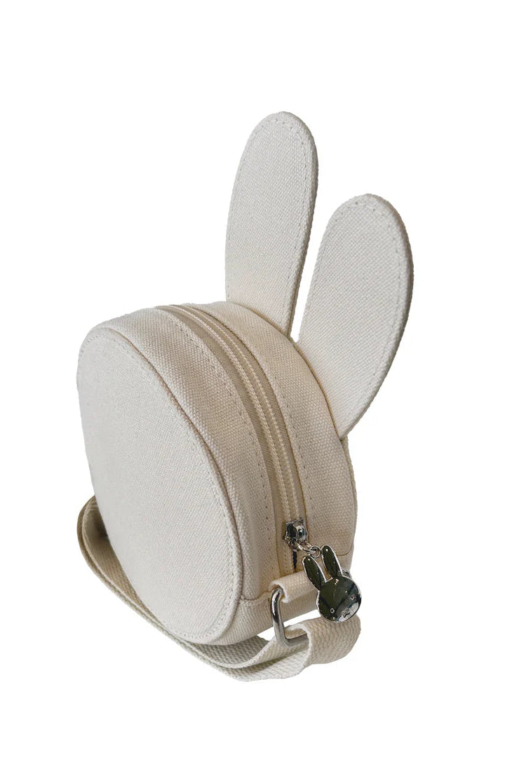 The ENGELITE Engelite - Miffy Canvas Ears Crossbody Bag Off White is a small, round cotton canvas kids bag featuring upright bunny ears, a matching strap, and a silver bunny-shaped zipper pull—perfect for little ones on the go.