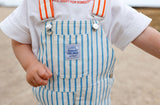 Close up of chest showing the logo badge detail on the front pocket of the Hola Ninch Overalls