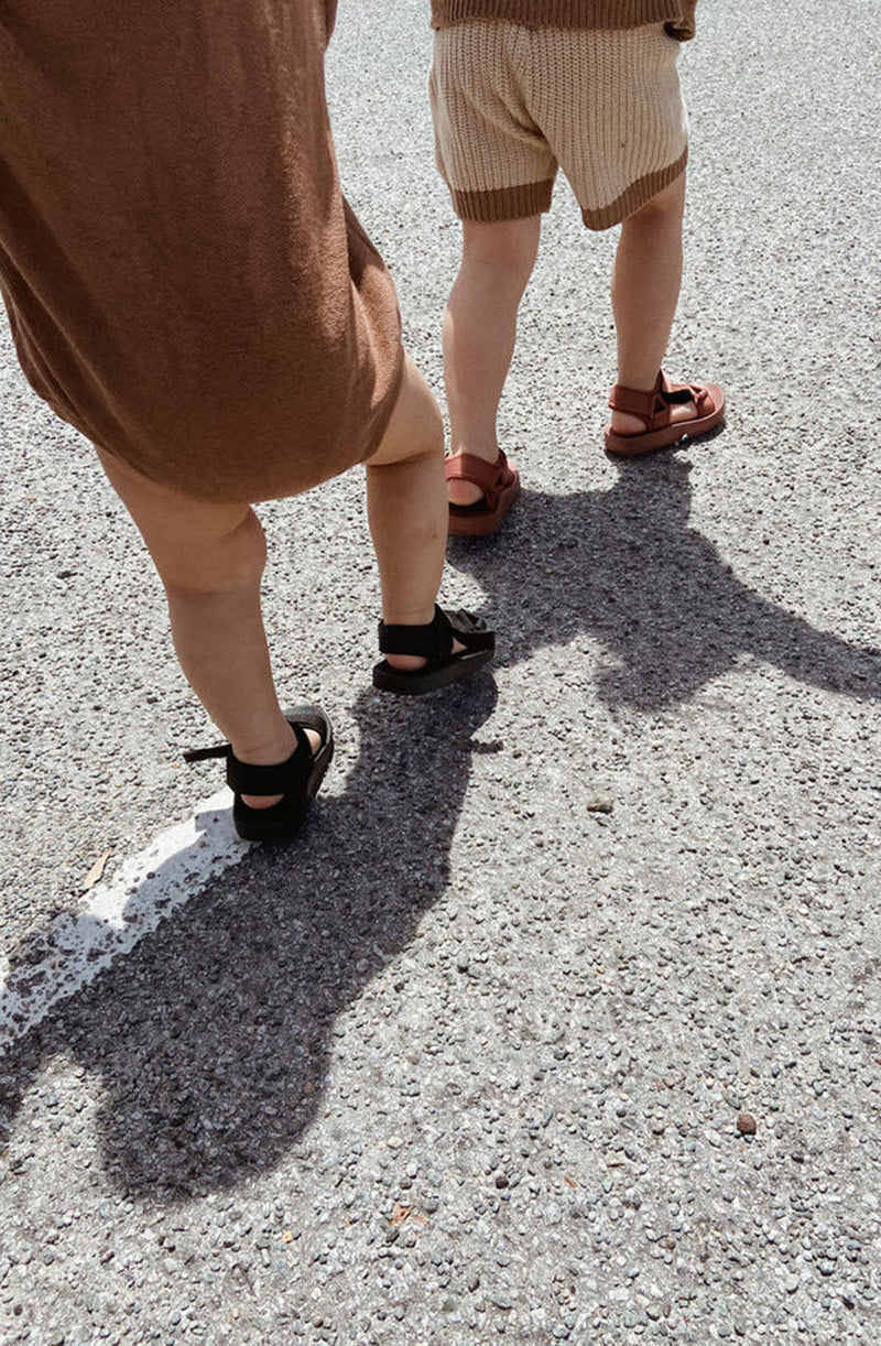 Two children walking while wearing the Olympia velcro sandals