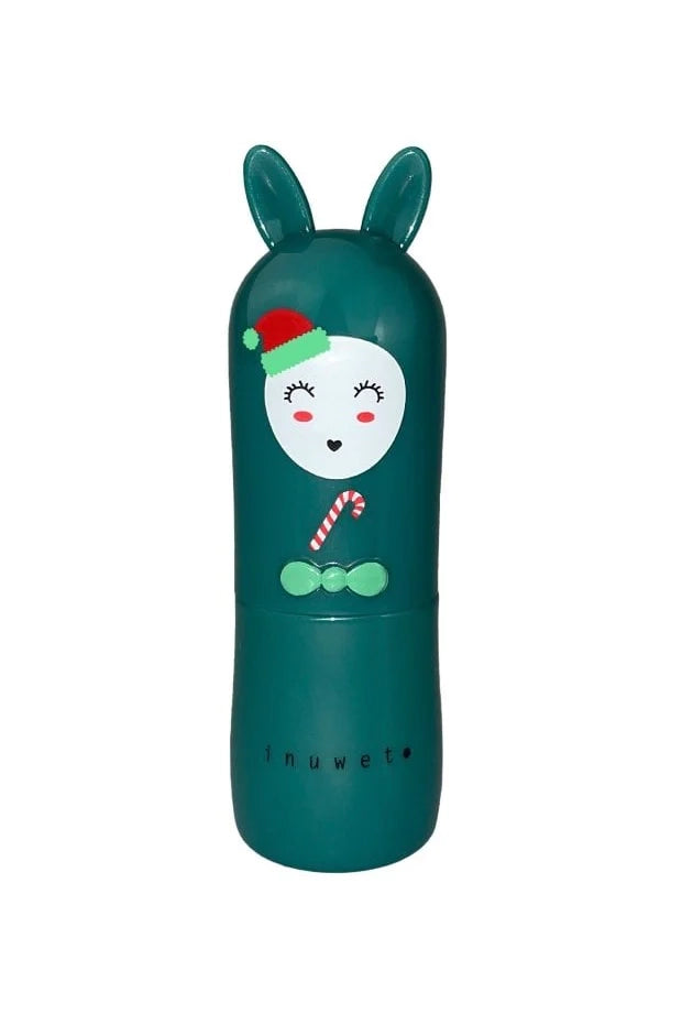 This charming teal lipstick case, decorated with a bunny-ear cap and featuring a jolly face adorned with a red Santa hat, closed eyes with eyelashes, alongside a bow tie and small candy cane detail, holds the vegan and cruelty-free *Christmas Lip Balm Cherry* by INUWET. The balm is cherry-scented, and the branding text "INUWET" is elegantly displayed near the bottom.