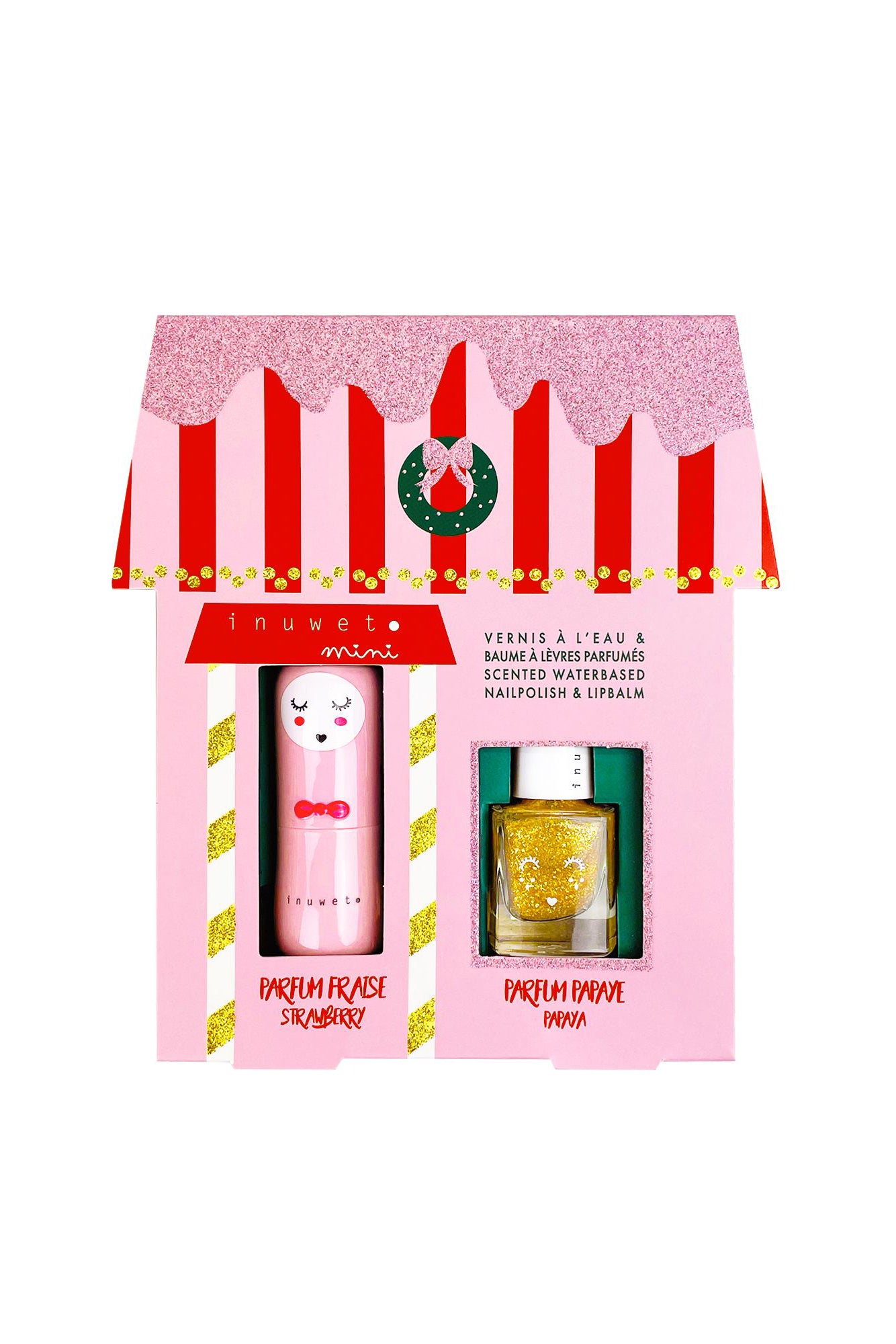 The La Maison Juliette Gift Box from INUWET, shaped like a house with glittery details, contains a strawberry-scented lip balm and children's water-based varnish. Its pink and red packaging showcases a decorative wreath design, adding the perfect touch of sparkle for festive celebrations.