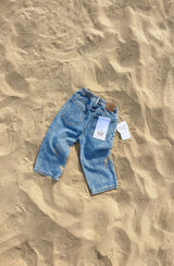 Back of Jagger jean flat laid on sand