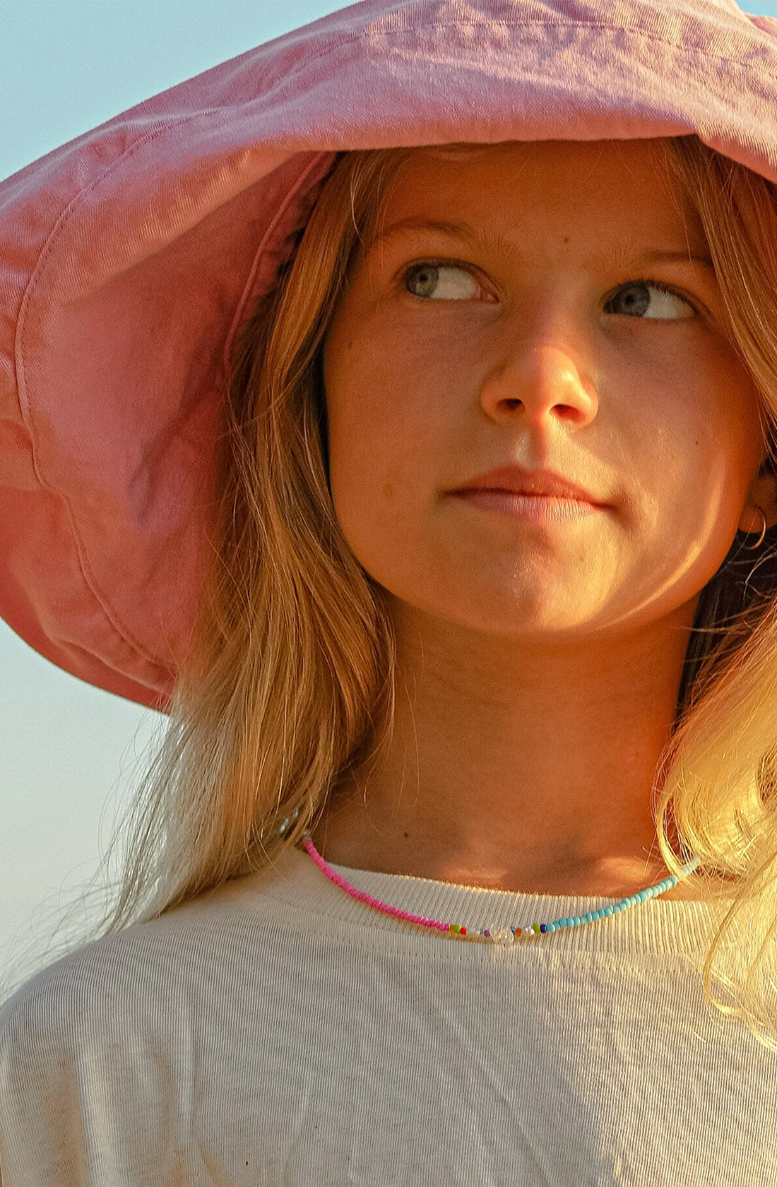 KRYSTLE KNIGHT JEWELLERY  Destiny Necklace on a young girl wearing a sun hat.