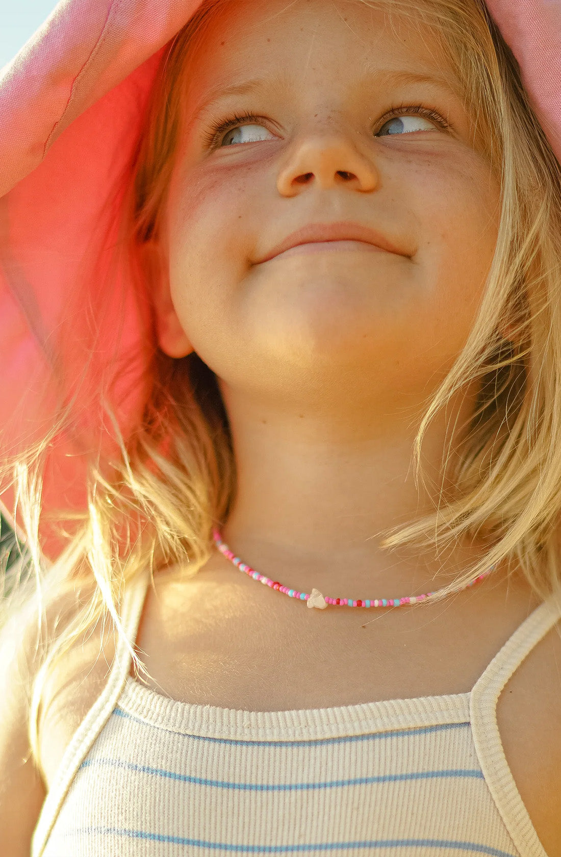 KRYSTLE KNIGHT JEWELLERY  Dusk Necklace worn by a young girl wearing a sun hat.