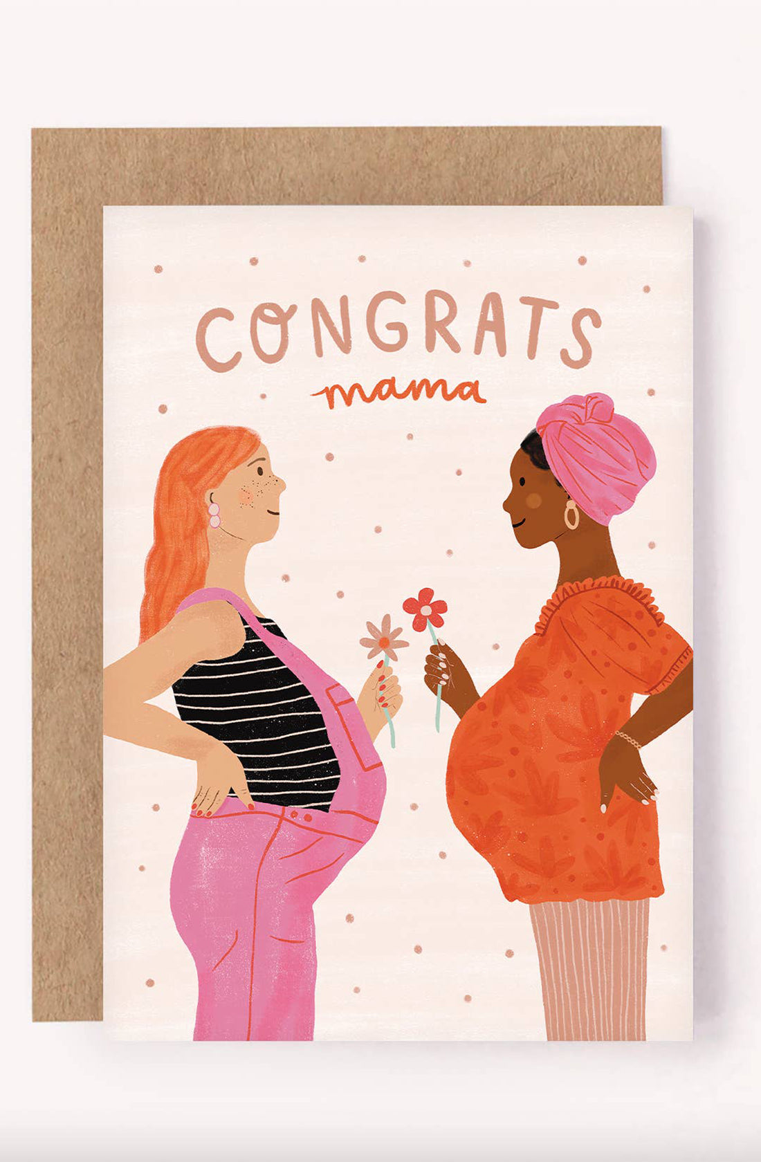 The Baby Shower Greeting Card "Congrats Mama" by LAUREN SISSONS STUDIO features an illustration of two pregnant women facing each other. One has long red hair, a striped top, pink overalls, and is holding a flower. The other has a pink head wrap and an orange dress, also holding a flower. Printed on recycled paper, the card reads "CONGRATS mama," making it the perfect baby shower gift for the new mom-to-be.