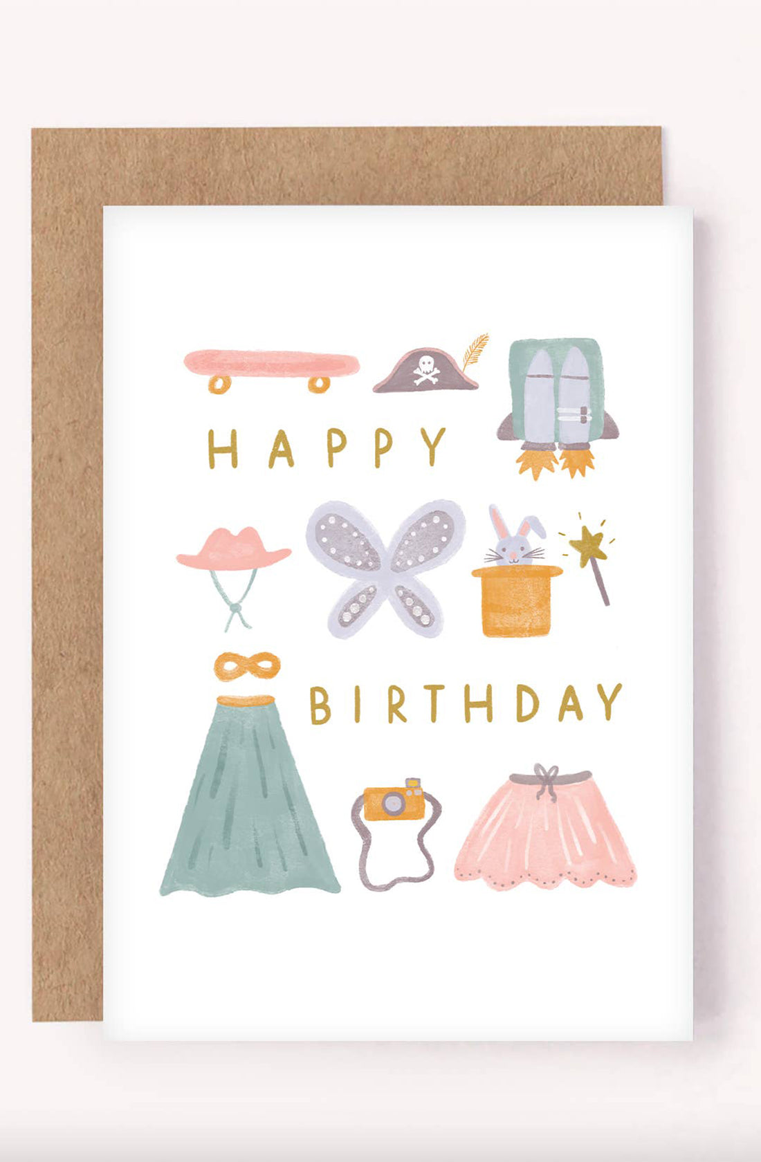 The Happy Birthday Greeting Card Kids Costume Box by LAUREN SISSONS STUDIO features a gender-neutral design with colorful illustrations that include a skateboard, pirate hat, birthday cake, butterfly wings, magician’s wand, mask, green dress, camera, and pink skirt. The text "HAPPY BIRTHDAY" is written in yellow capital letters in the middle on recycled paper.