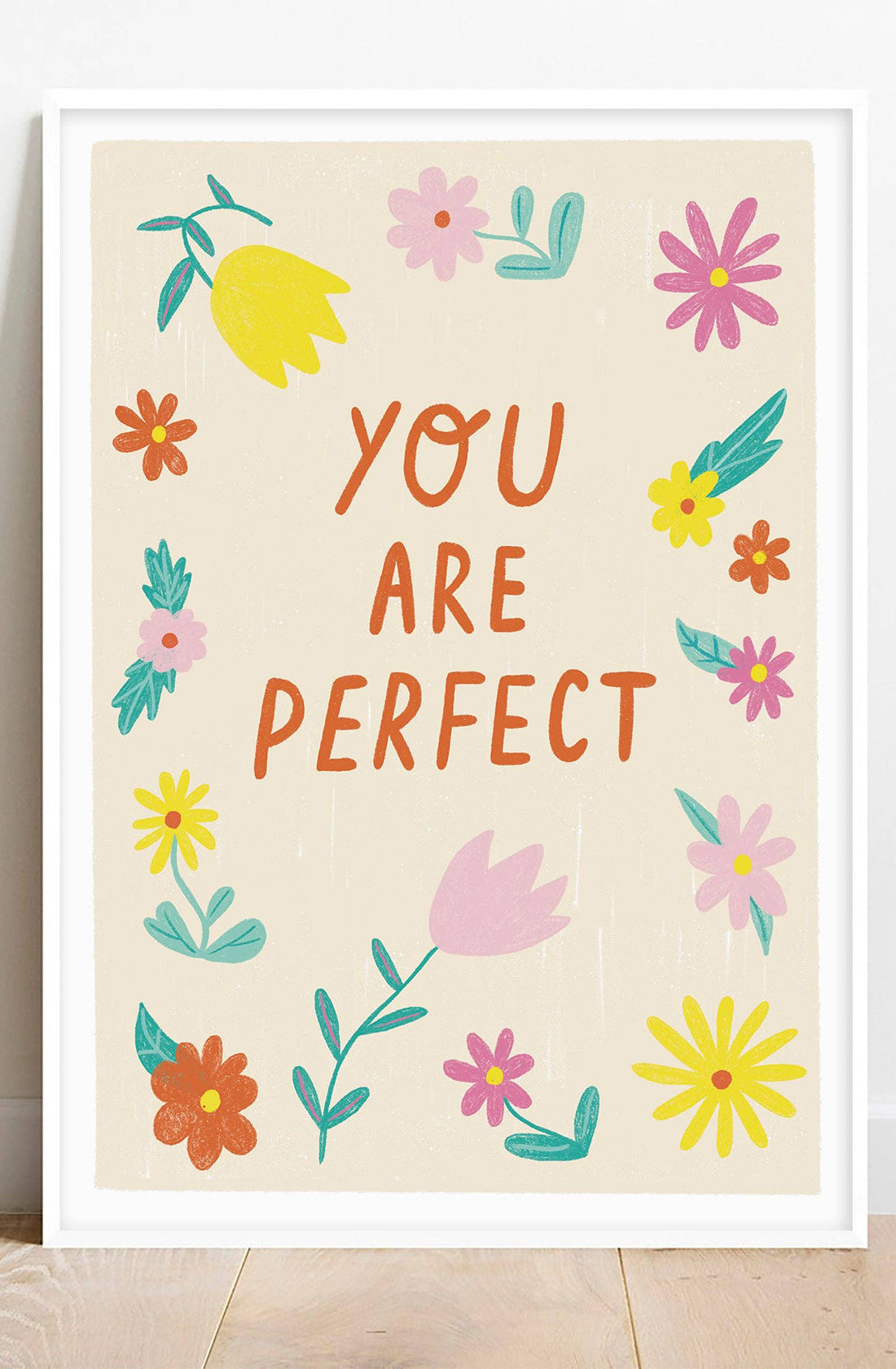 An art print with the words "you are perfect" on it with yellow pink and red flowers surrounding it, designed by Lauren Sissons Studio.