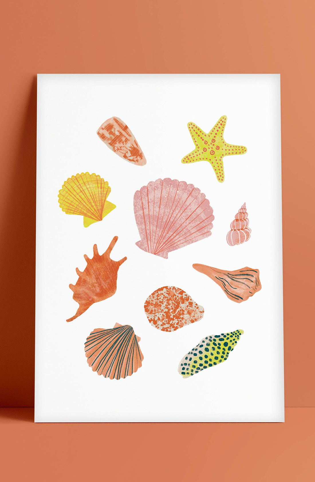 The Seashell Wall Art Print by LAUREN SISSONS STUDIO showcases an A4 size illustration featuring a variety of colorful sea shells and one starfish against a plain white background, all encased in a white frame. The image is thoughtfully presented on high-quality archival matte paper with the sea shells varying in shape, size, and color, set against an orange backdrop.