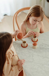Two girls sitting at a table having a tea party