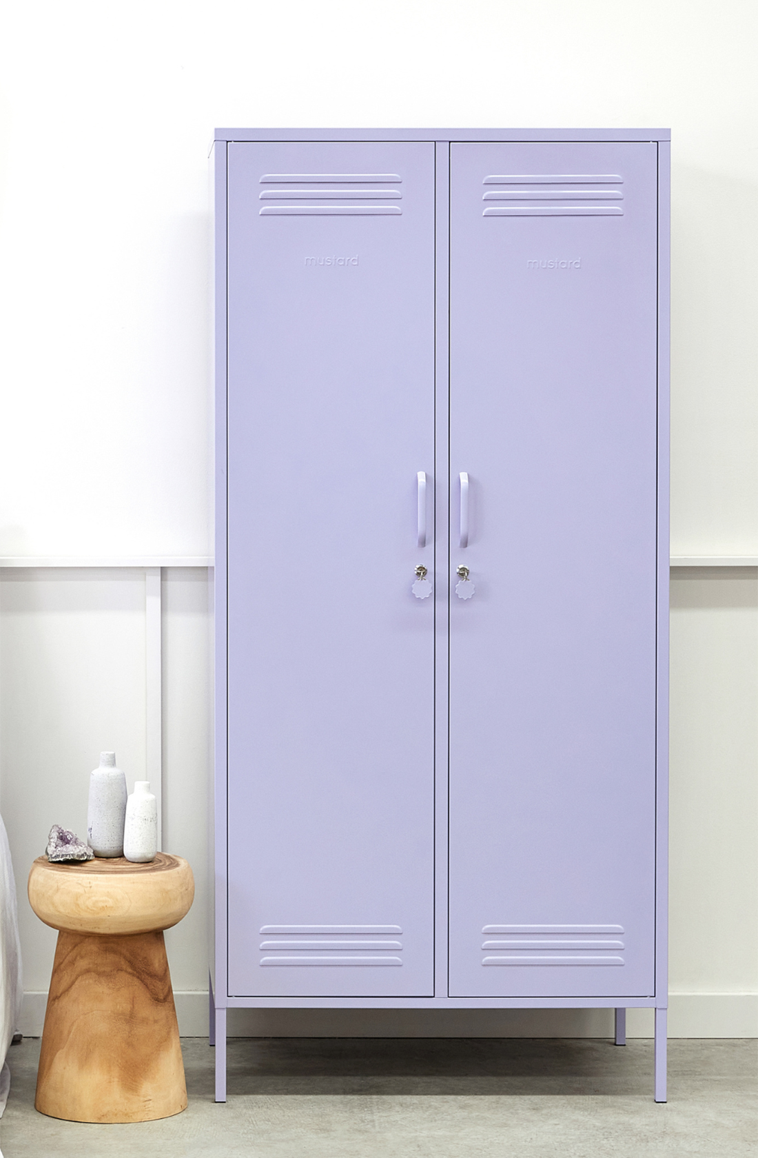 The twinny locker in lilac next to a side table.