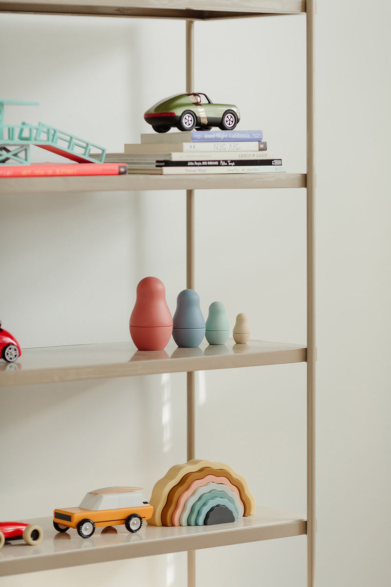 Rainbow stacking toy on bookshelf