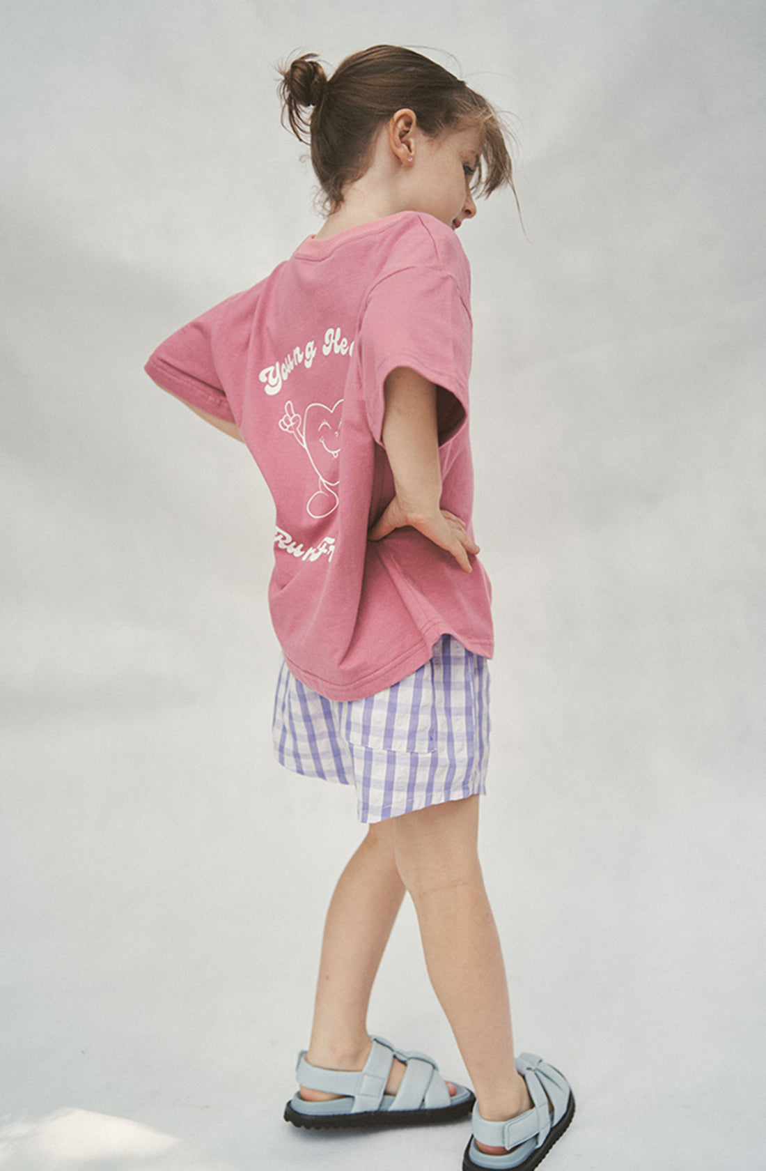 Brunette girl standing backwards with hands on hips wearing the Cami shorts