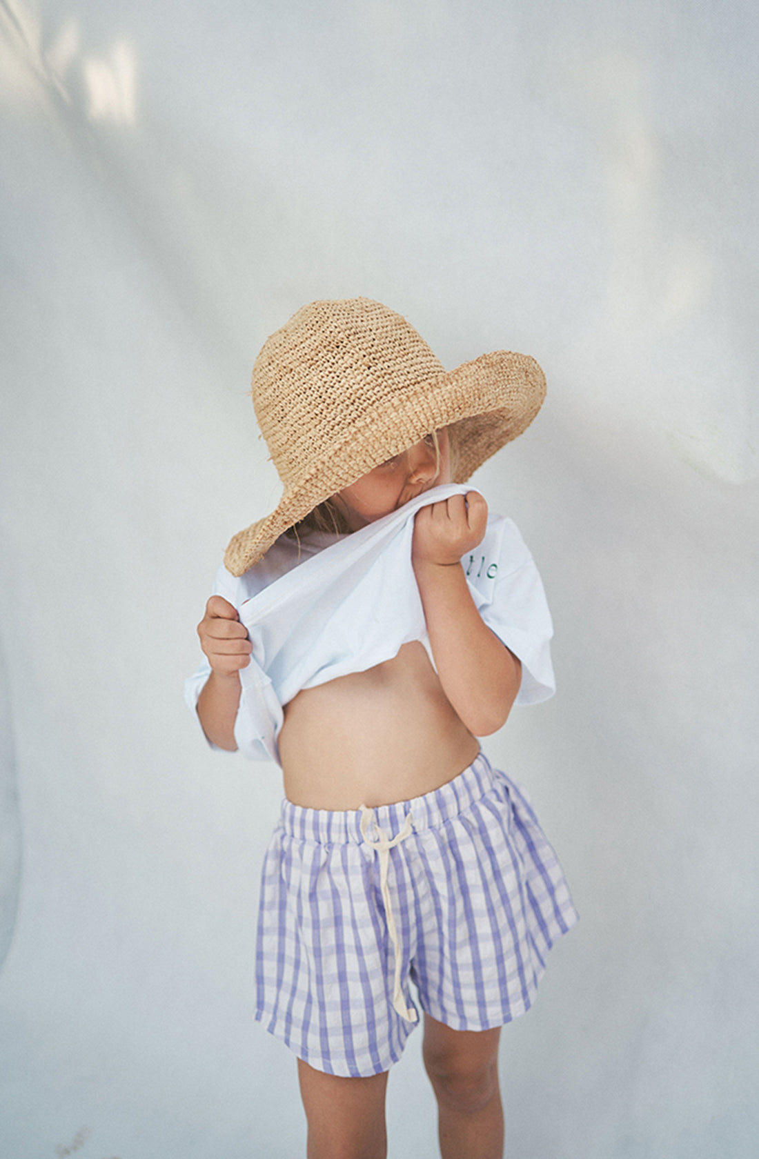 Girl pulling up her t-shirt to show Cami shorts