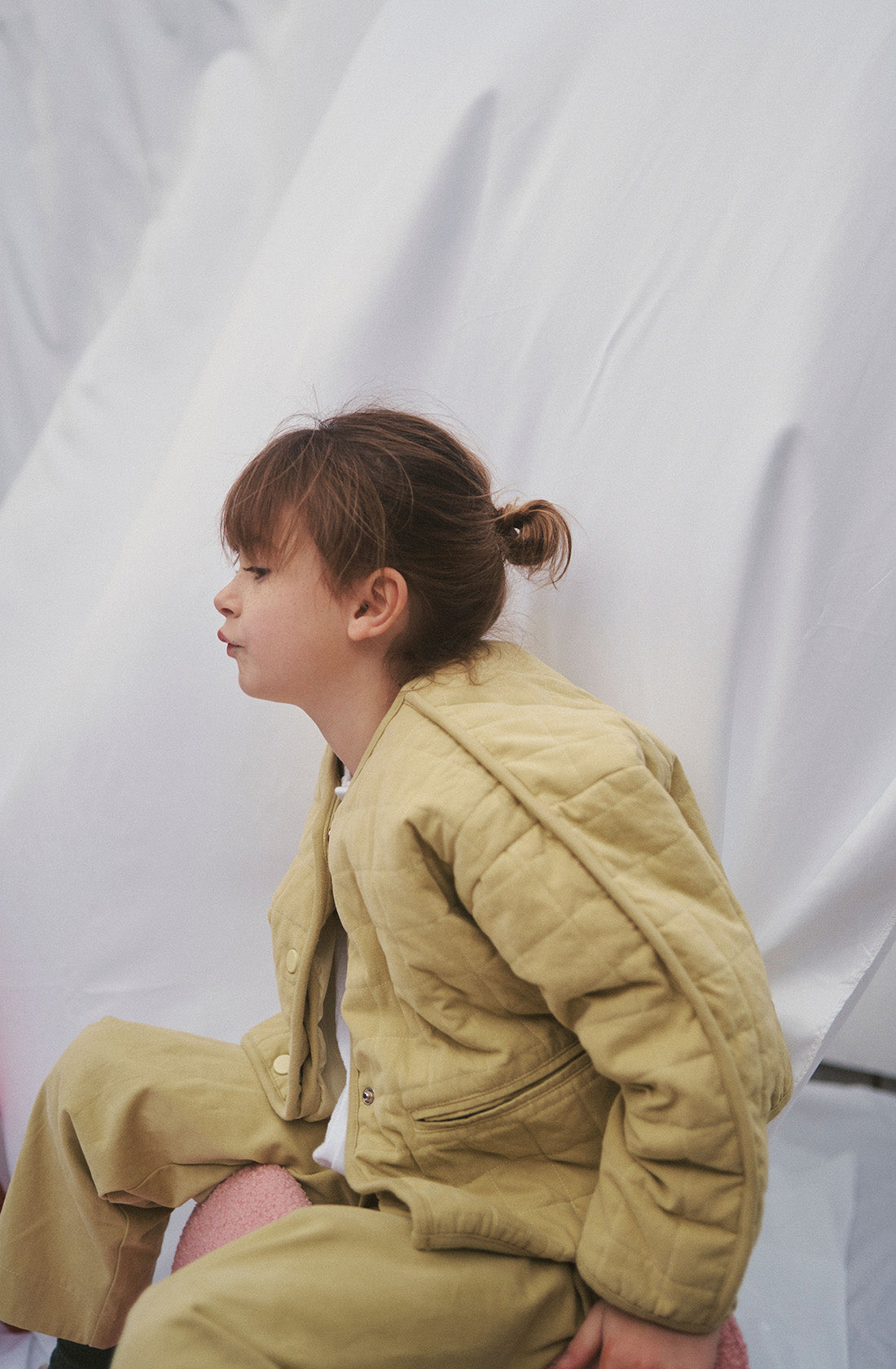 Young kid wearing the parker quilted jacket and mustard pants.