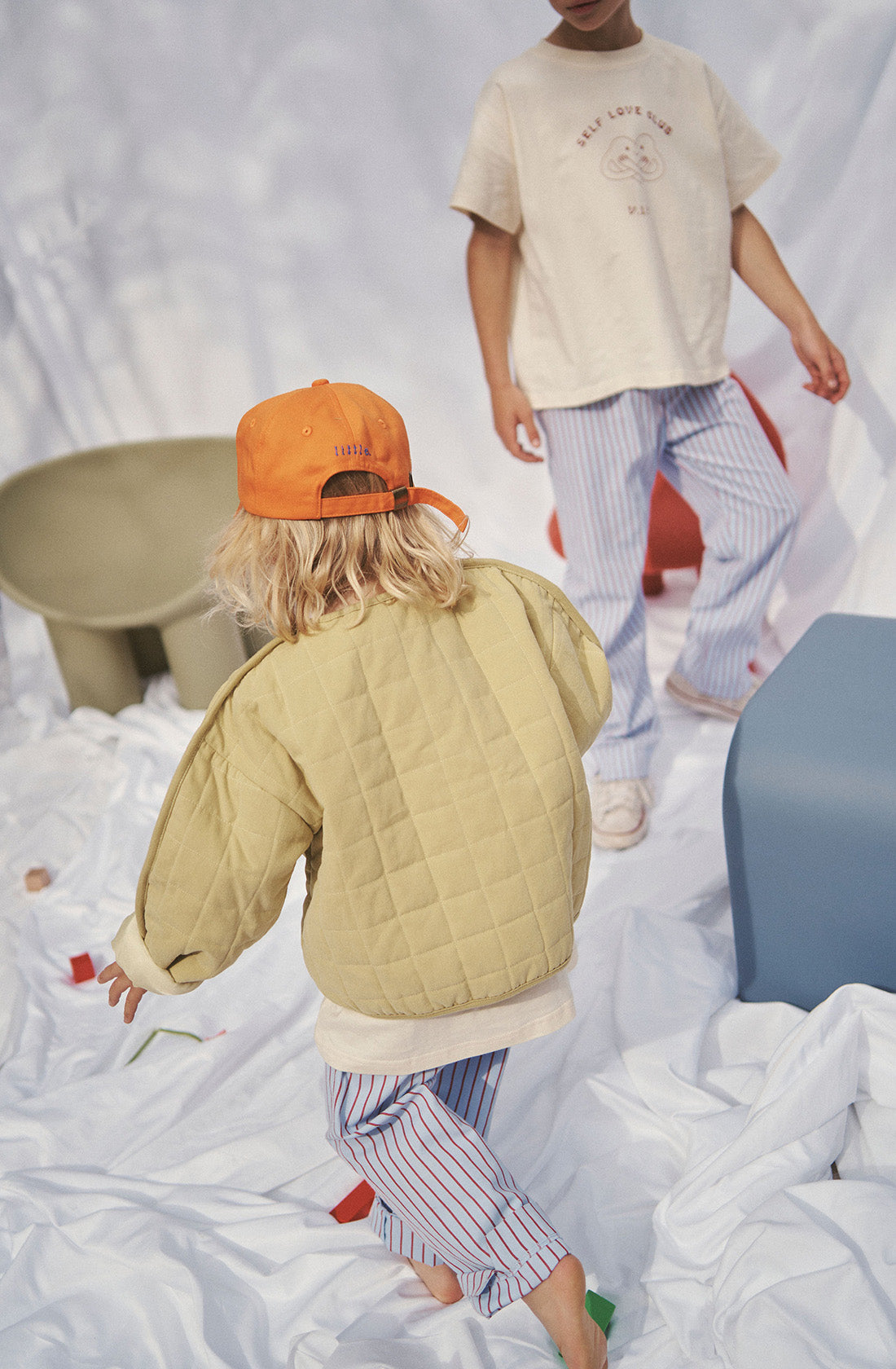 Young kid wearing the parker quilted jacket and striped pants.