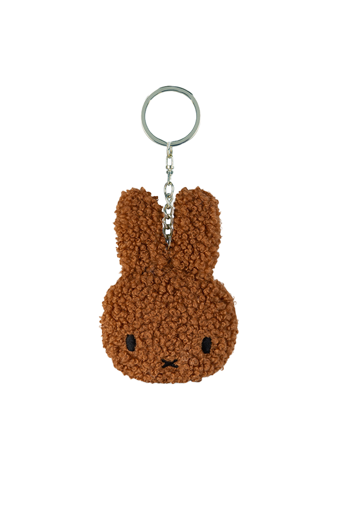 Introducing the Miffy Flat Keychain Tiny Teddy Cinnamon from BON TON TOYS X MIFFY: a charming and fluffy brown keychain shaped like a rabbit's head with distinctive long ears. This eco-friendly accessory, made from recycled polyester, features black embroidered eyes and a small "x" for the mouth, reminiscent of classic Miffy designs. It is securely attached to a metal keyring via a short chain.