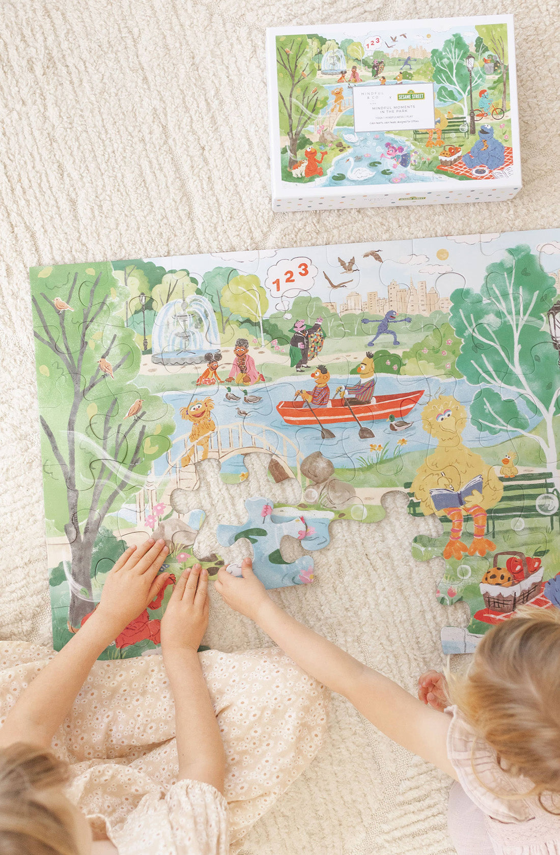 Two kids playing with the Sesame street floor puzzle 