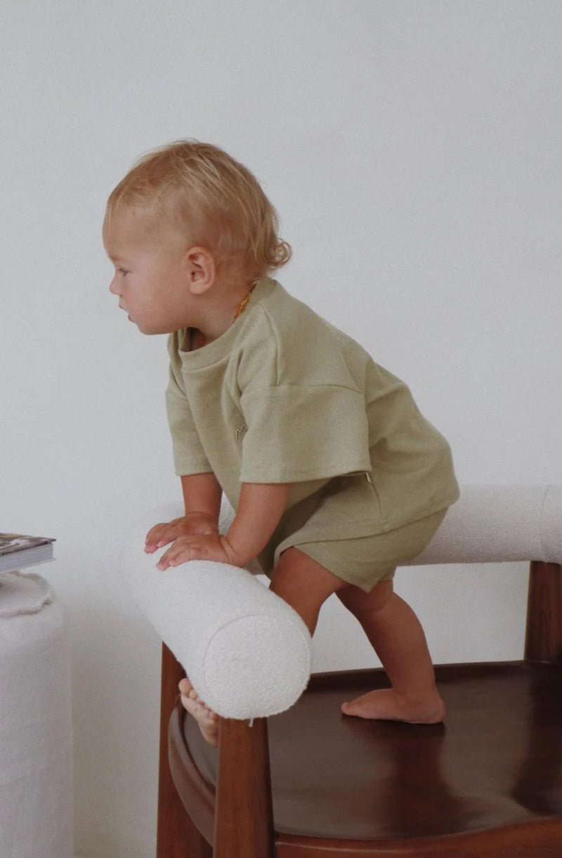 Boy standing on chair wearing the essential matching set in sage