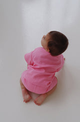 Baby crawling on floor wearing the essential set in sherbet pink
