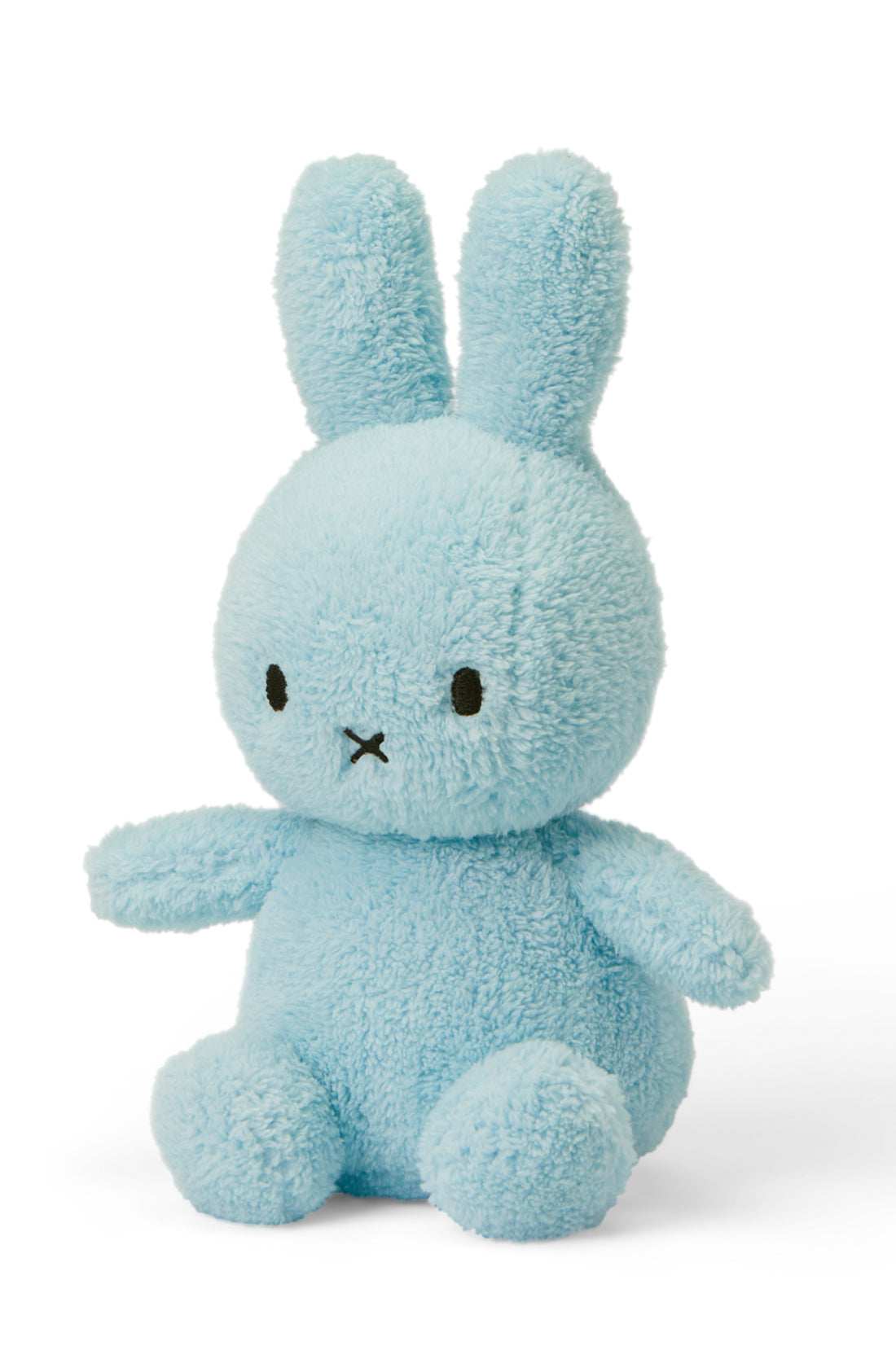 The Miffy Sitting Terry Light Blue 23 cm plush bunny from the BON TON TOYS X MIFFY Collection features light blue fur and sits upright. It has long ears, round black eyes, and a small 'X'-shaped mouth. Filled with recycled polyester for added sustainability, this cuddly toy is the ultimate baby gift against a plain white background.