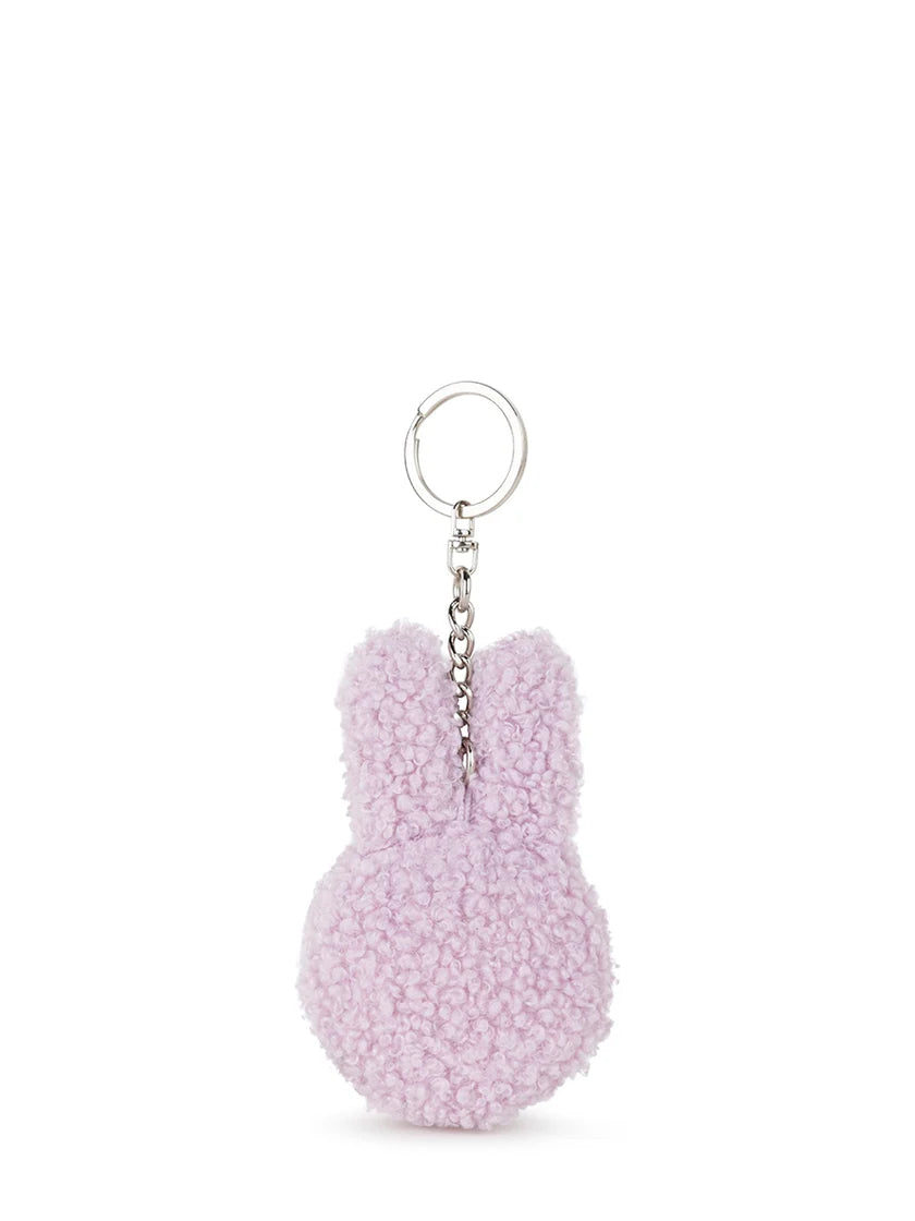 The Bon Ton Toys - Miffy Flat Keychain Tiny Teddy Lavender by BON TON TOYS X MIFFY is a pastel purple bunny head keychain made from recycled polyester, with a silver ring and chain—an adorable accessory for your bag.