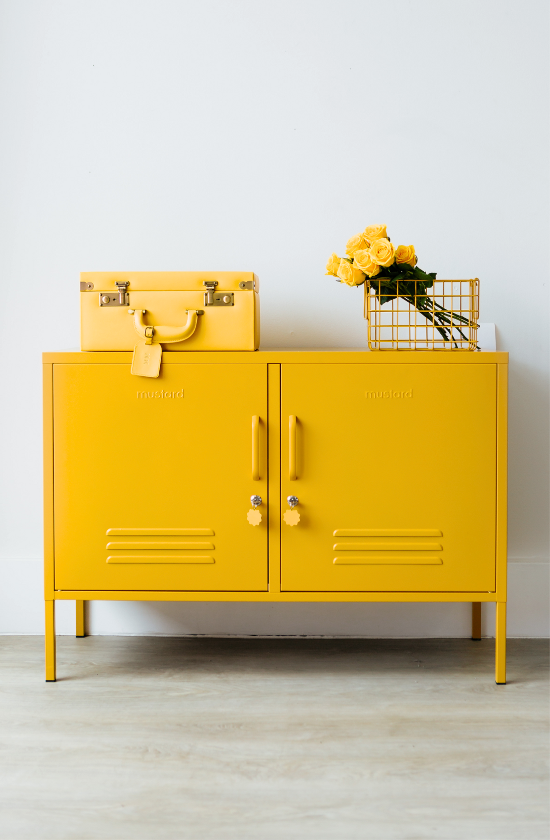 The lowdown locker in mustard with a basket and case on top..