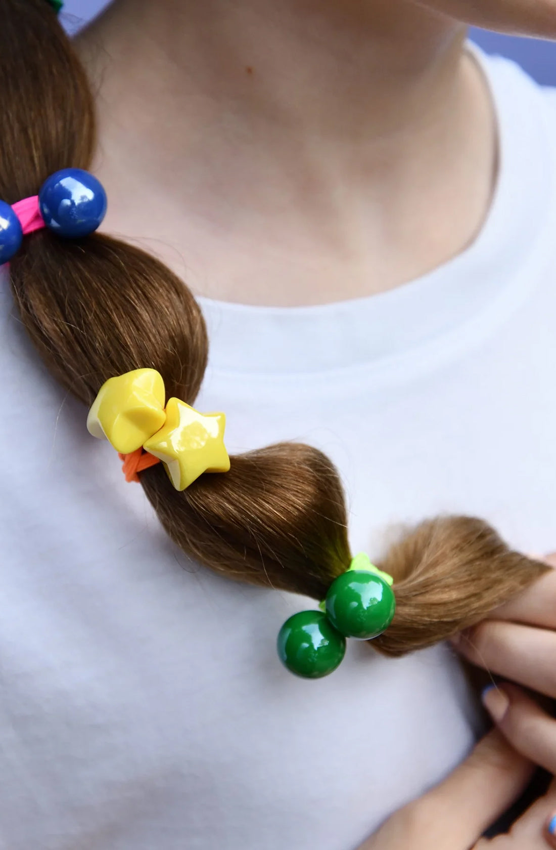 Close up of the starlight bobbles hair ties in a young girls hair.