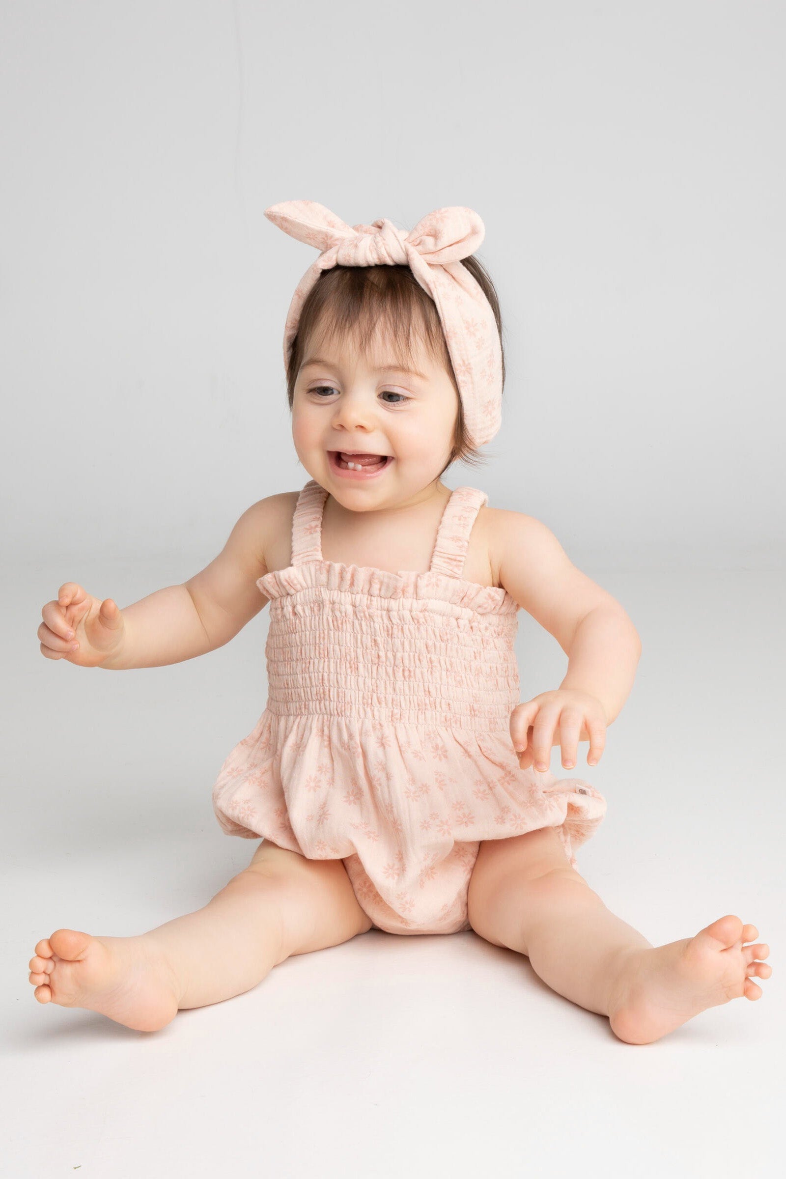 Baby wearing matching headband and romper