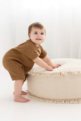 Baby wearing slouchy rib knit romper in copper