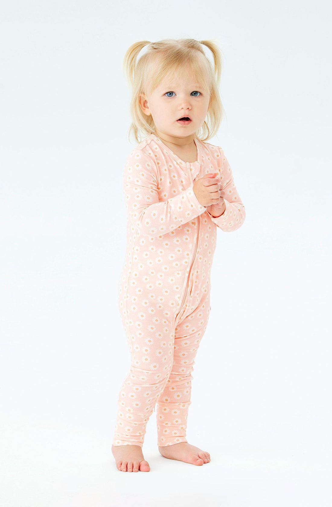 A Toddler wearing the Day or Night Onesies Daisy Charm.