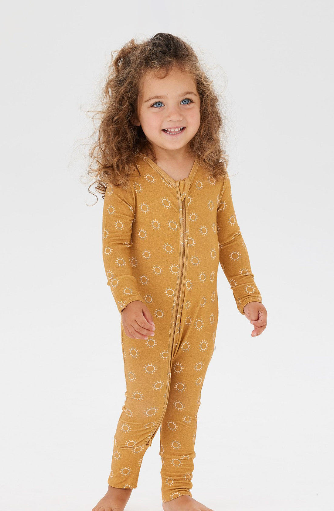 A Toddler wearing the Day or Night Onesies Sunrise.