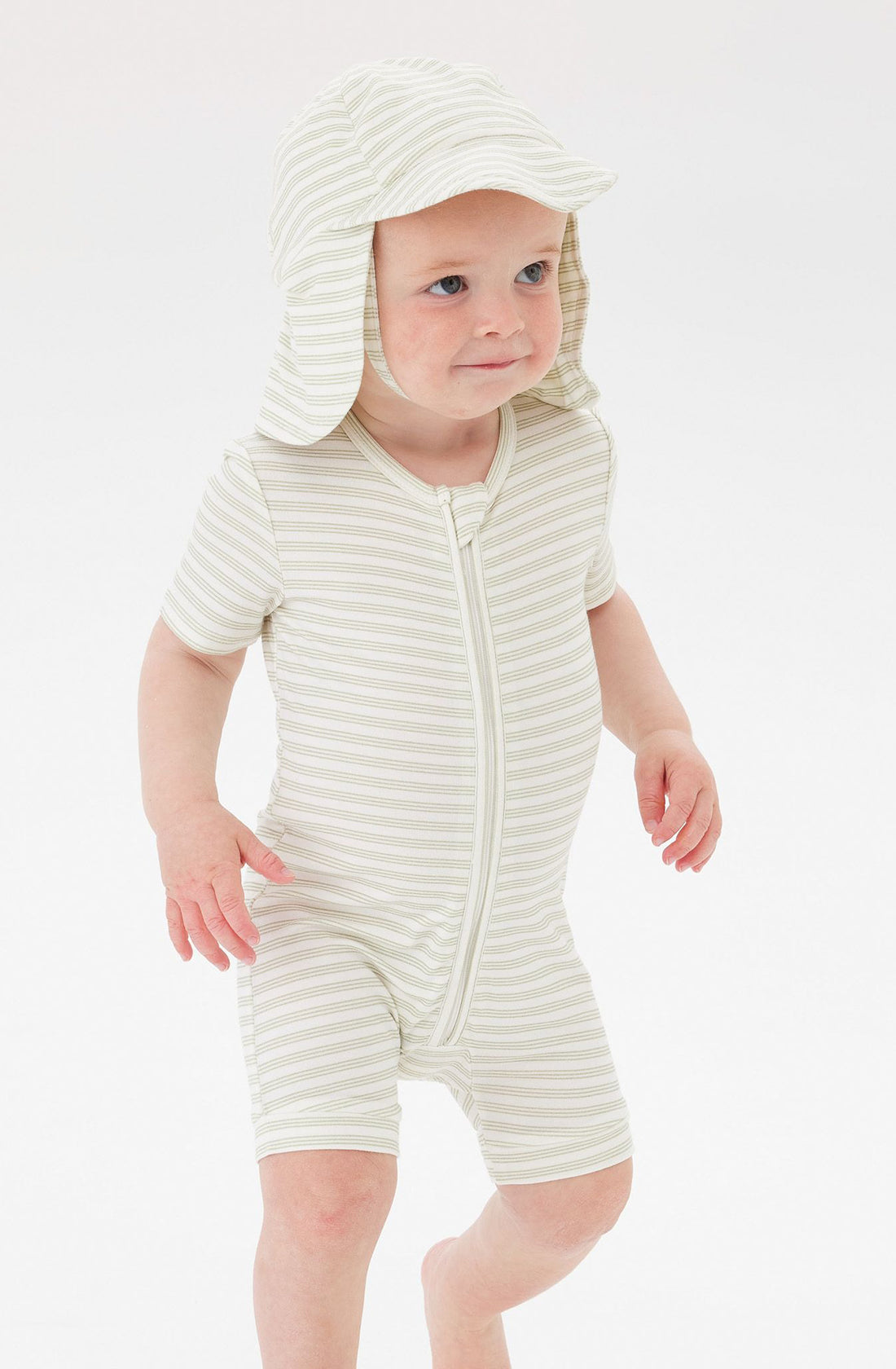 A Toddler wearing the Day or Night Short Sleeve Onesie Sage Stripe with matching hat.