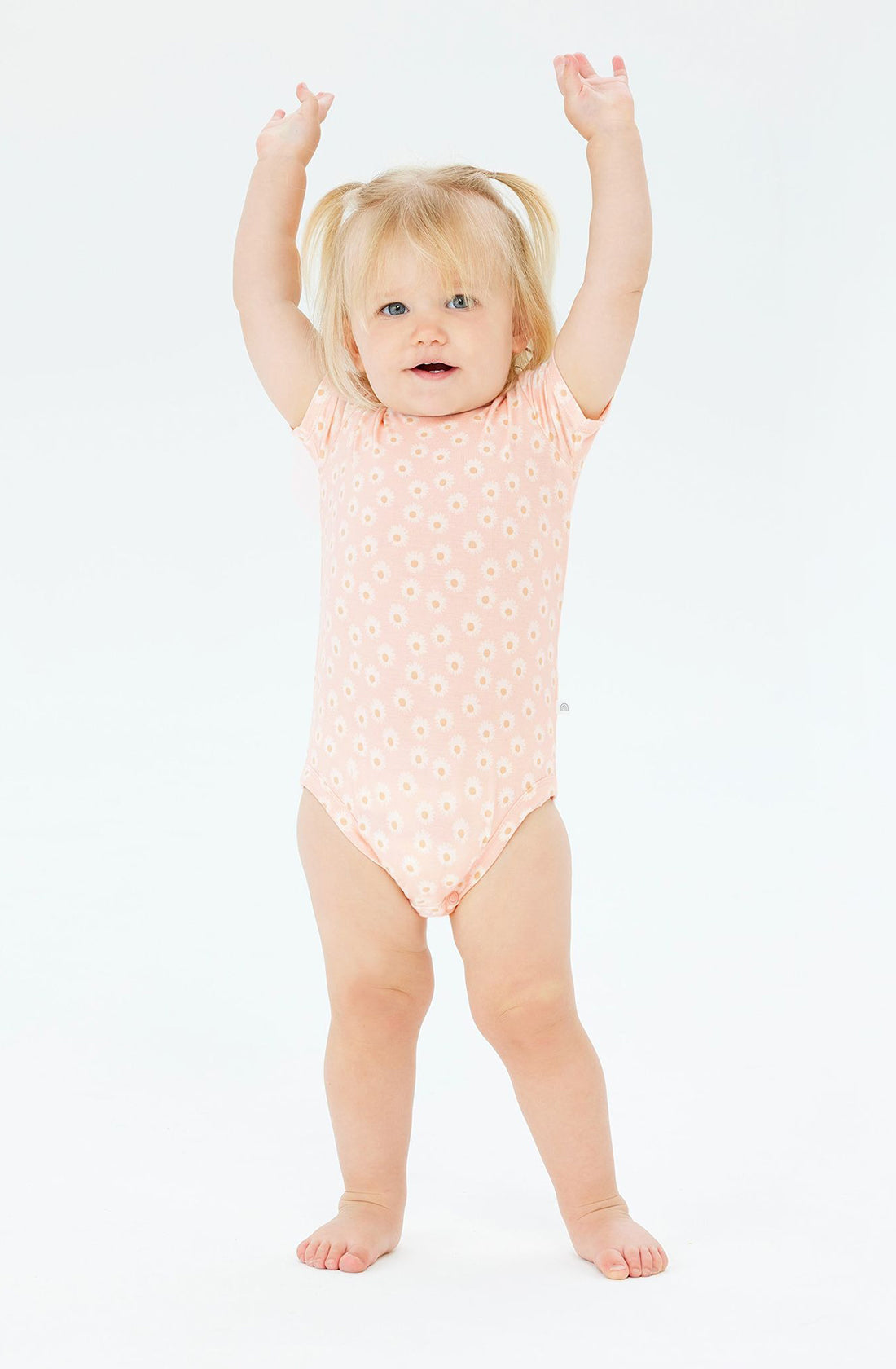 A baby wearing the KYND BABY Comfy Bodysuit Short Sleeve Daisy Charm.