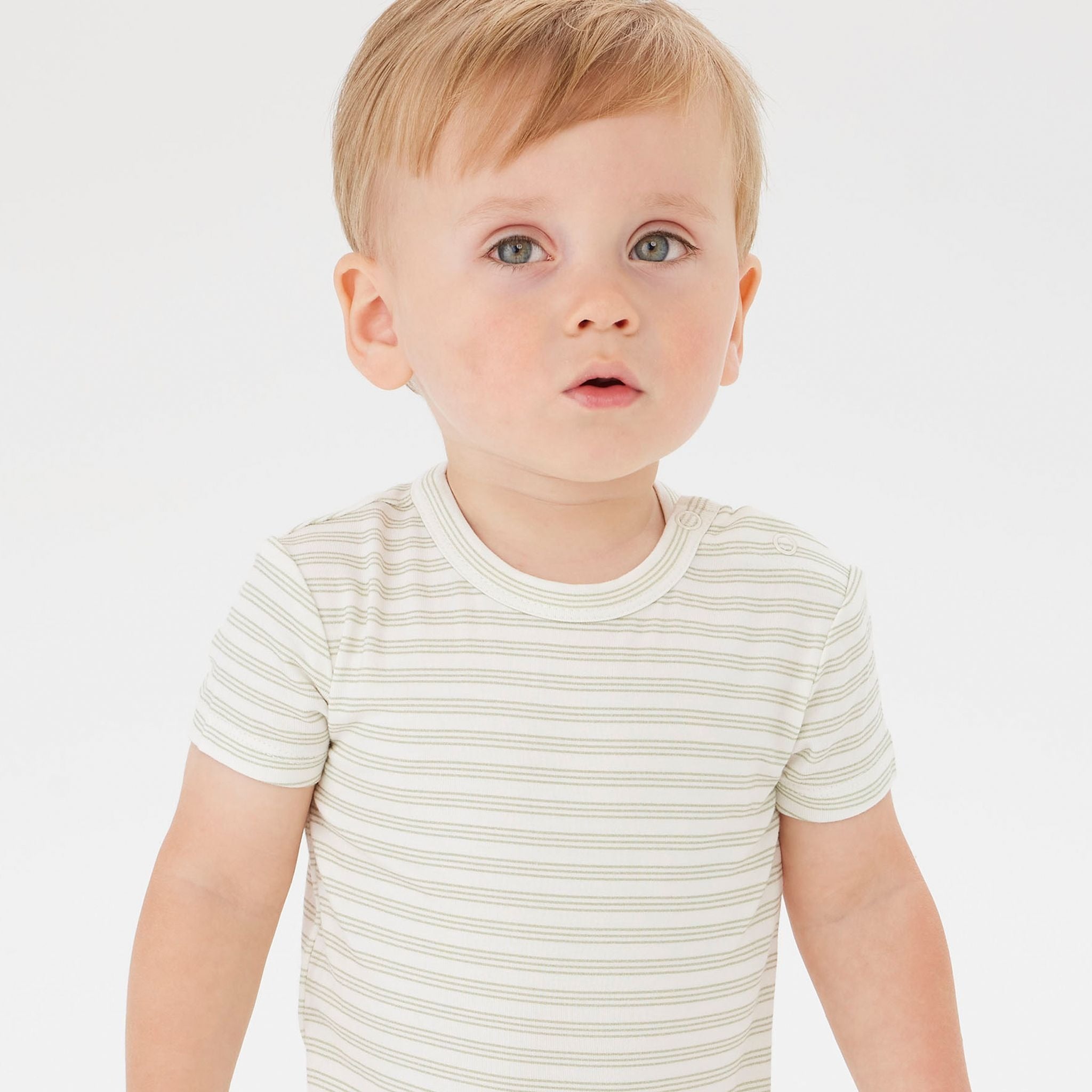 A baby wearing the KYND BABY Comfy Bodysuit Short Sleeve Sage Stripe.