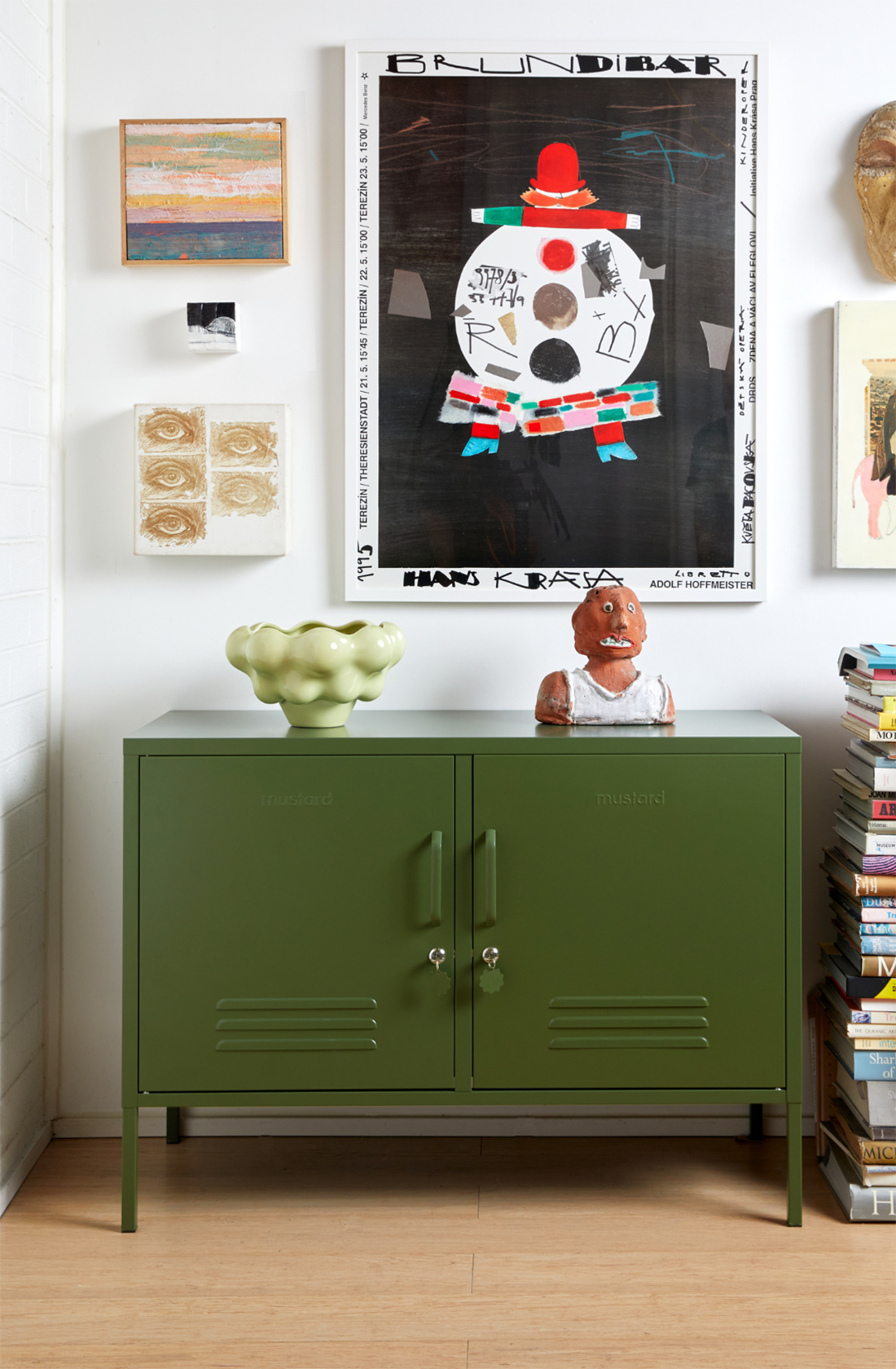 The lowdown locker in olive with two vases on it.