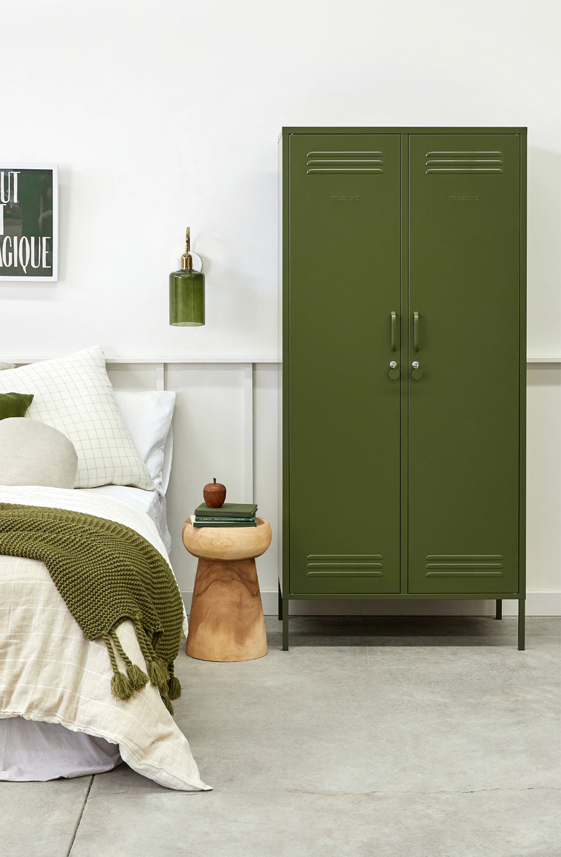 The twinny locker in olive next to a bed.