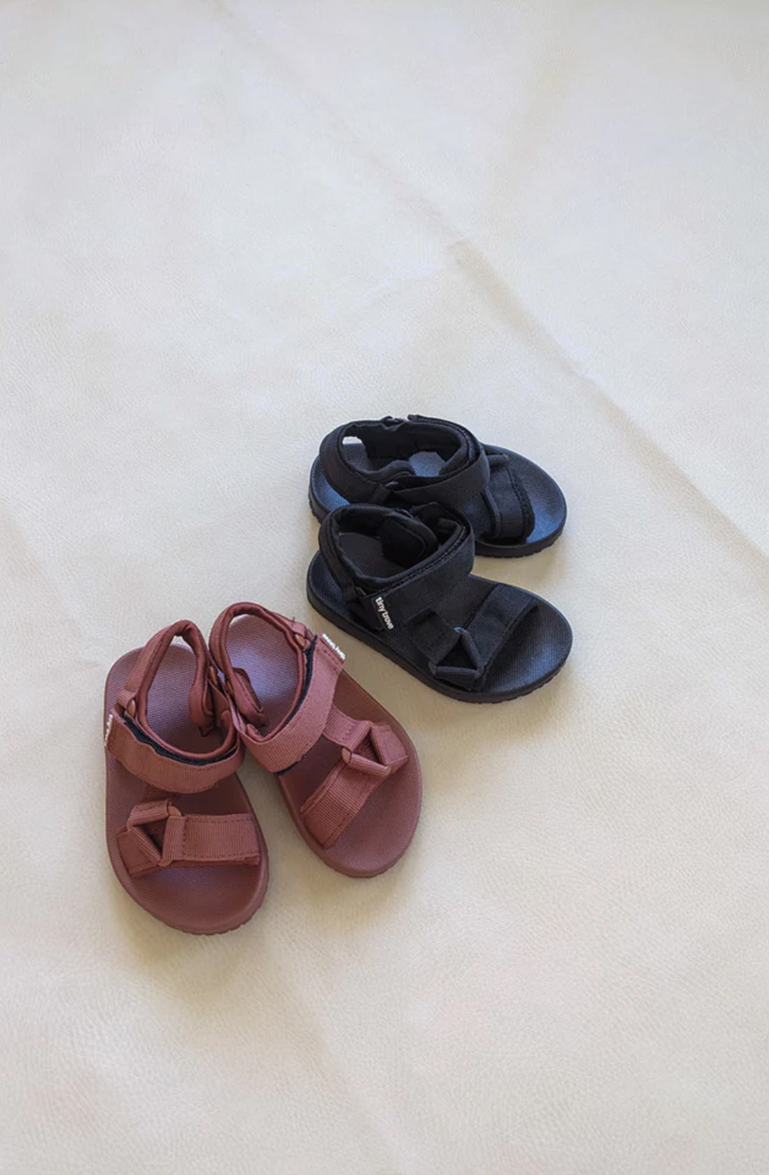 Brick and Black sandals on grey background