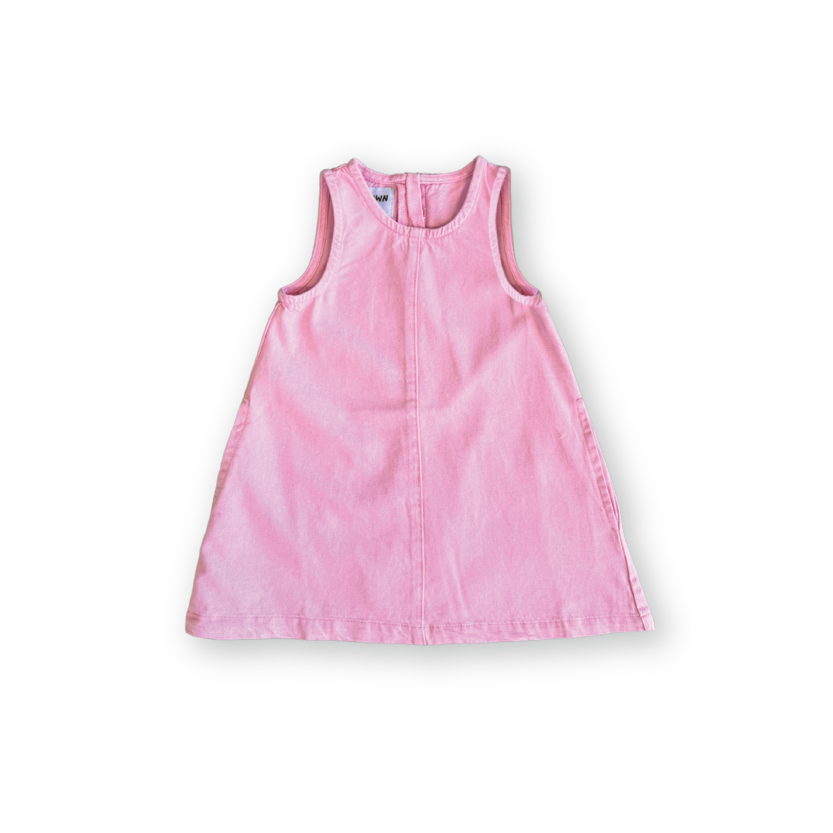 The GROWN Organic Shift Denim Dress Candy is a sleeveless, light pink dress for kids, crafted from soft organic cotton denim with an easy zipper. Shown against a plain white background.