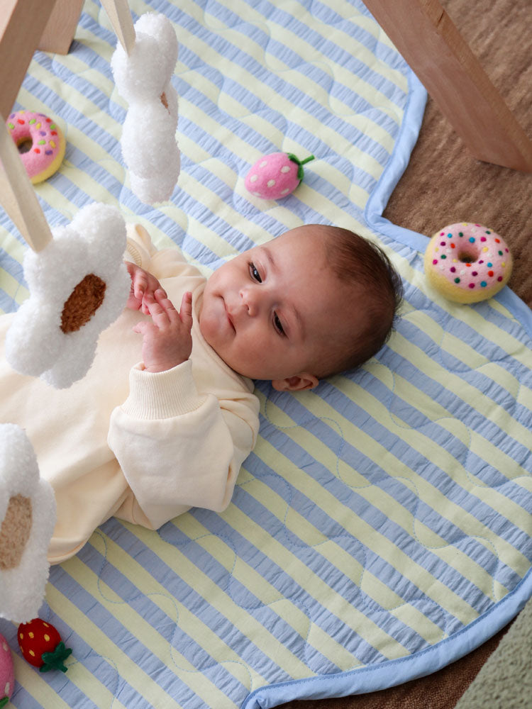 Mosey Me Butter Blue Seersucker Playmat styled in nursery