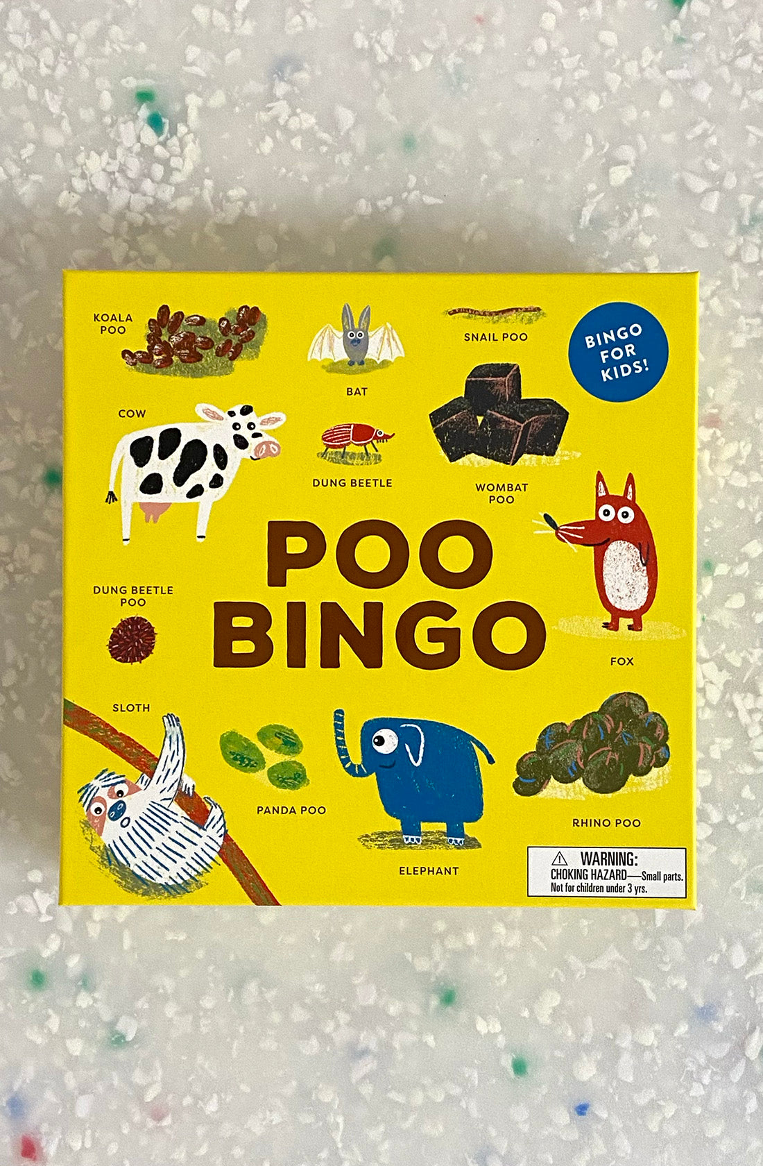 A yellow "Poo Bingo" game box by BAY KIDS features illustrations of various animals and their poos, including a koala, cow, bat, snail, dung beetle, wombat, sloth, panda, fox, elephant, and rhino. The box reads "Bingo for Kids!" and includes a warning for small parts. Perfect for young animal enthusiasts!