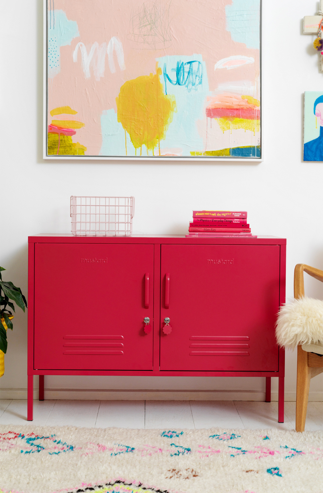 The lowdown locker in poppy in living room with basket and books on top..