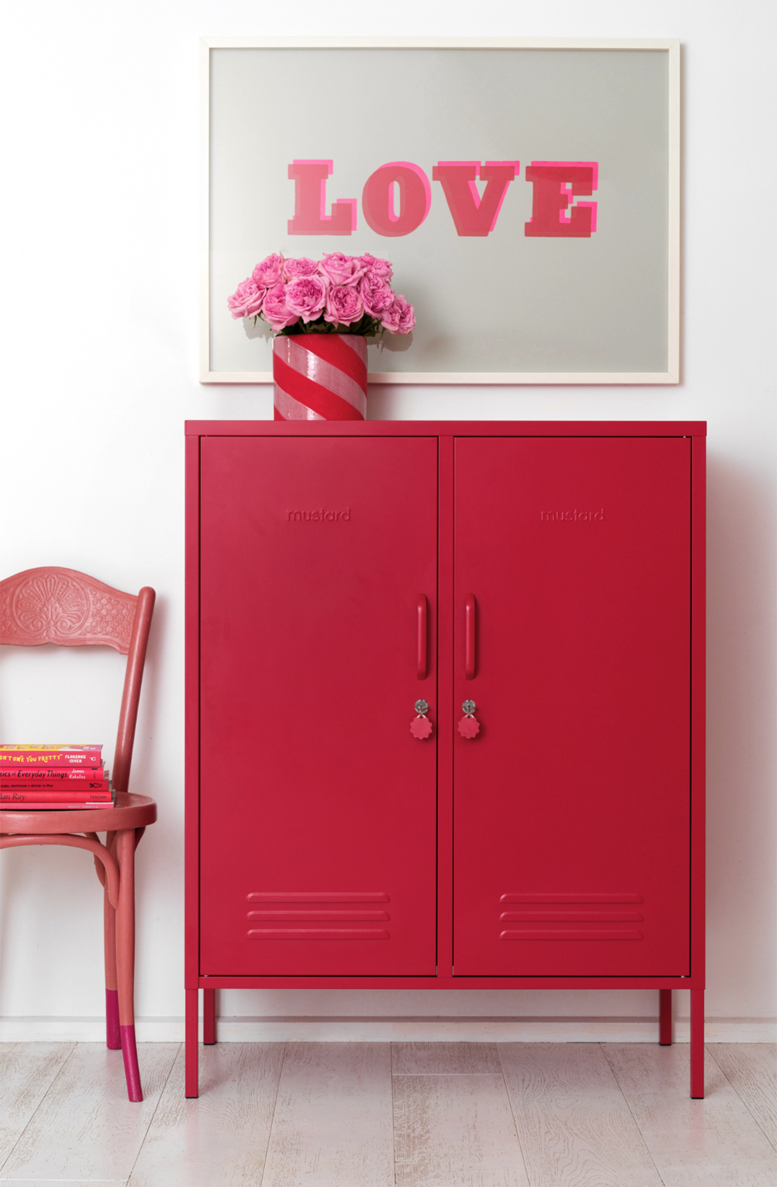 The midi locker in poppy next to chair.